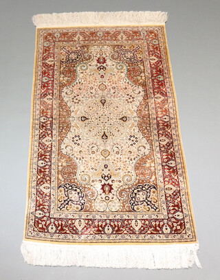 A North West Persian brown and white ground silk rug with central medallion within a multi row border 155cm x 93cm 
