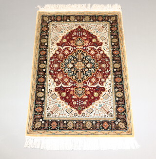 A North West Persian brown, black and white ground silk rug with central medallion within a multi row border 140cm x 94cm 
