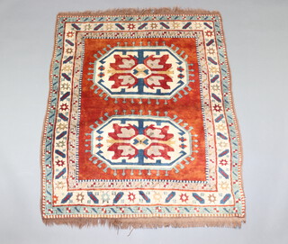A brown, green and white ground Caucasian style rug with 2 octagons to the centre within a multi row border 146cm x 121cm 