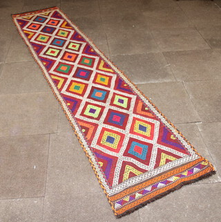 A red, white, orange and blue Suzni Kilim runner with overall geometric design 304cm x 64cm 