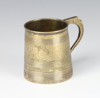 A George III silver mug of tapered form with reeded decoration and engraved monogram, London 1808, 7cm, 148 grams 