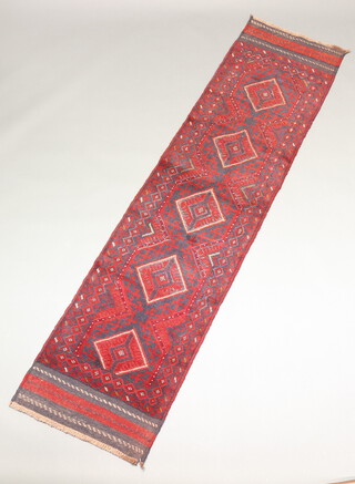 A red and blue ground Meshwani runner with 5 diamonds to the centre 251cm x 61cm 