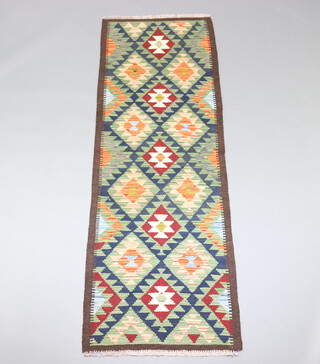 A green, orange and brown ground Maimana Kilim runner with all over geometric designs 200cm x 70cm 
