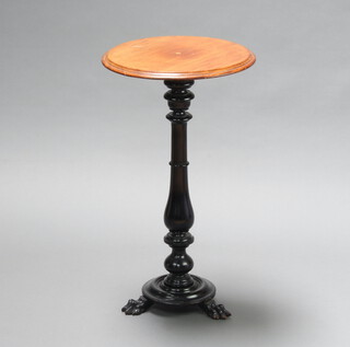 A Victorian circular walnut wine table raised on an ebonised baluster turned column with paw feet 72cm h x 41cm diam. 