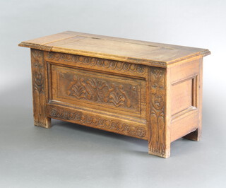 A 17th Century style carved oak coffer of small proportions with hinged lid 44cm h x 91cm w x 36cm d 