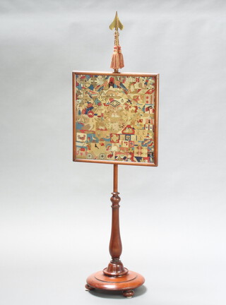 A Victorian turned mahogany pole screen with brass finial and Berlin woolwork panel 144cm x 29cm diam. 