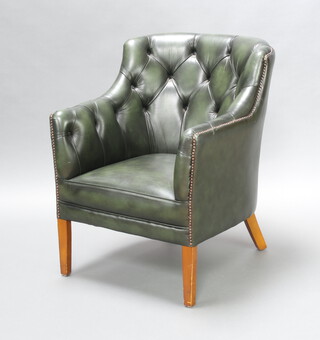A Georgian style tub back club armchair upholstered in green buttoned leather, raised on square supports 84cm h x 67cm w x 57cm d (seat 31cm x 35cm) 