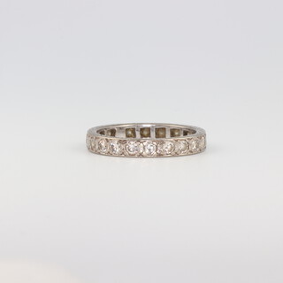 A white metal diamond eternity ring, size M, 3.2gms