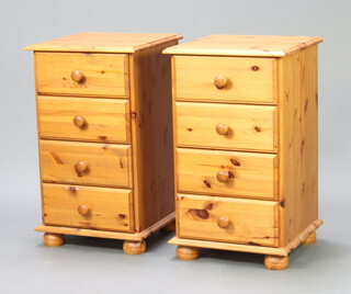 A pair of pine pedestal chests of 4 drawers, raised on bun feet 77cm h x 45cm w x 45cm d 