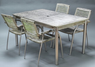 A tubular polished steel and hardwood slatted garden set comprising rectangular table 76cm h x 150cm l x 90cm w together with 4 open arm chairs 85cm h x 56cm w x 60cm (1 chair is missing 2 slats to the base) 