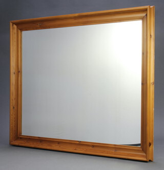 A plate wall mirror contained in a pine frame 138cm x 107cm 