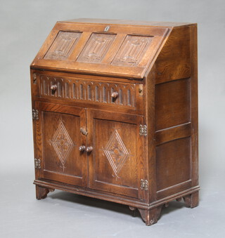 An oak bureau, the fall front with carved linenfold decoration above a drawer and cupboard enclosed by panelled doors, raised on bracket feet 91cm h x 76cm w x 42cm d (contact and water marks)  
