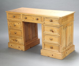 A pine kneehole pedestal desk fitted 1 long and 8 short drawers 78cm h x 129cm w x 52cm d (contact marks in places, stain to top left hand corner)