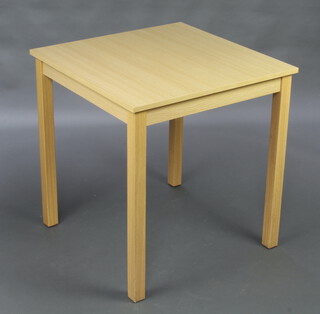 A wooden laminate finished table raised on square supports 74cm h x 70cm w x 70cm d 