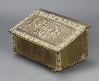 A wedge shaped embossed brass slipper box, the lid decorated Eastern figures 23cm x 42cm x 28cm 
