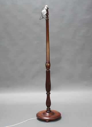 A turned mahogany standard lamp with circular base 147cm h x 34cm diam. 