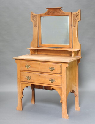 An Edwardian Art Nouveau carved satinwood dressing chest with rectangular bevelled shaped mirror above a shelf, base fitted 2 drawers, on shaped supports 152cm h x 90cm w x 45cm d (Silvering to the mirror is showing signs of deterioration, ring, water and contact marks throughout) 