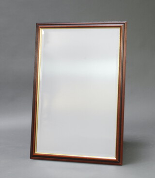 A mahogany finished rectangular bevelled wall mirror 70cm x 100cm 