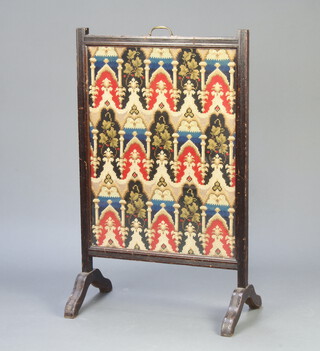 An Edwardian fire screen with woolwork panel 104cm h x 62cm w x 36cm d (missing finials to the top) 