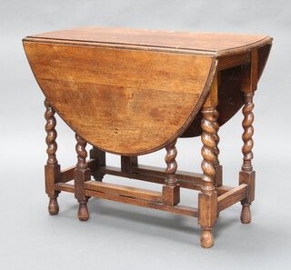 A 1930's oval oak drop flap gateleg tea table, raised on spiral turned supports 72cm h x 92cm w x 41cm d (ink and water marks to the top, 1 gateleg requires attention) 