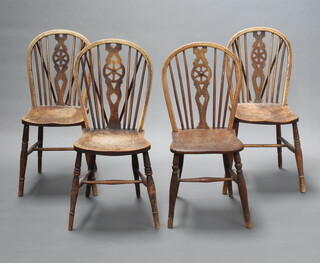 A set of 4 elm wheel back dining chairs with solid elm seats raised on turned supports with H framed stretcher 88cm h x 37cm w x 37cm d (frames loose)