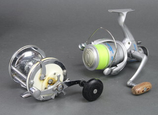 A Storm 460 fishing reel together with spare spool and a Mitchell 624 fishing reel 