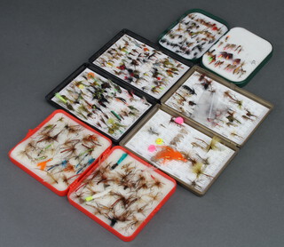 An Osprey fishing fly box containing a collection of various flies, 2 plastic Fox Box fly boxes containing a collection of various flies and a red Leeda fly box