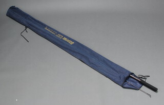 A Storm Pro Bass 11'3" two section fishing rod in a blue cloth bag 