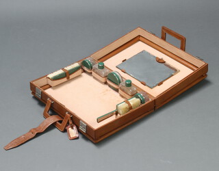 A vintage leather vanity case with chromium mounted accessories 