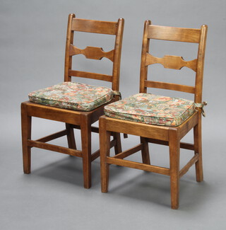 A pair of 19th Century oak country bar back dining chairs with solid seats raised on square supports with box framed stretchers 90cm h x 46cm w x 40cm d (seat 30cm x 28cm, both have signs of old but treated worm, 1 missing small section of timber to right hand side of the bar back) 