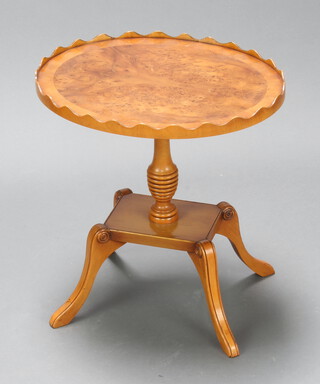 An oval Georgian style walnut wine table raised on a pillar and tripod base 46cm h x 45cm w x 37cm d 