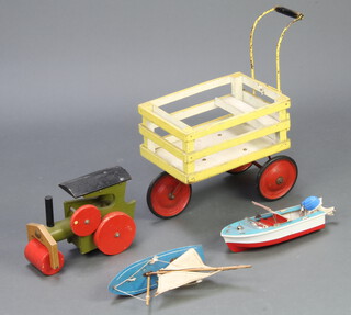 A Star pond yacht with blue hull 12cm x 28cm x 7cm, a battery operated motor boat 6cm x 30cm x 11cm, a painted wooden steam roller 20cm x 25cm x 23cm together with a yellow painted 3 wheeled dairy cart 49cm x 39cm x 24cm 