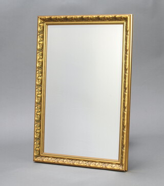 A rectangular bevelled plate wall mirror contained in a gilt frame 61cm h x 85cm w 