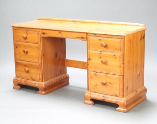 A pine desk/dressing table fitted 7 drawers 76cm h x 142cm w x 46cm d (contact marks and scratches) 