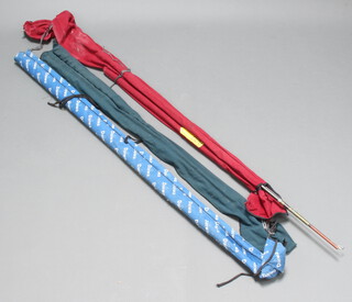 A Zebco Express Match 3600 fishing rod in a green cloth bag, a Daiwa Harrier-X fishing rod in a blue cloth bag, an Abu fishing rod in a red cloth bag 