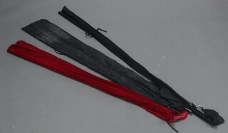 A Shakespeare International carp fishing rod in a red cloth bag, a Daiwa graphite sensor leges fishing rod in a black cloth bag and a 12' heavy fender/arun rod in a black cloth bag 