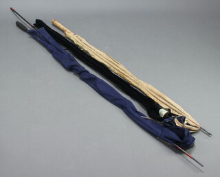 A Sealey Specimen fishing rod in a blue cloth case, a Shakespeare International carbon 1856 rod in a black case and a Team Daiwa rod 