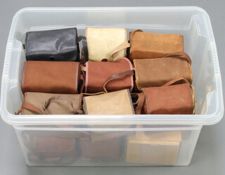 A collection of various box cameras contained in a clear plastic crate