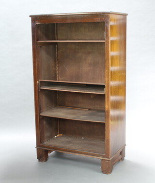A 1930's mahogany bookcase fitted adjustable shelves, raised on shaped supports 159cm h x 89cm w x 49cm d 