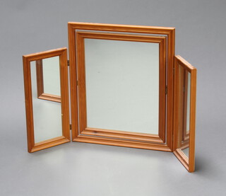 A triple plate dressing table mirror contained in a pine frame 52cm x 83cm 