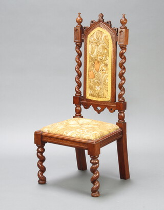 A Victorian Gothic style mahogany hall chair with upholstered seat and back and spiral turned columns to the side, raised on square turned supports 107cm h x 48cm w x 40cm d (seat 20cm x 21cm, crude screw repair to the right hand column) 