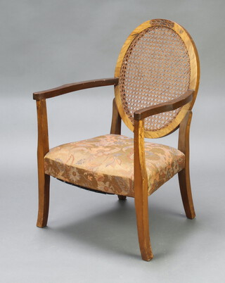 A 1950's beech framed open arm chair with woven cane back and upholstered seat, raised on shaped supports 85cm h x 57cm w x 51cm d  
