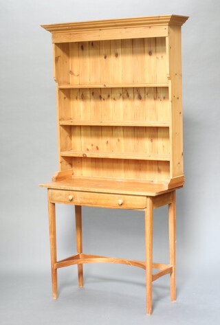 A pine and mahogany dresser, the pine top with moulded cornice fitted 3 shelves above a bleached mahogany base fitted a drawer with shaped stretcher and square tapered supports 190cm h x 175cm w x 39cm d (ring marks in places) 