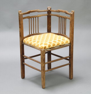 An Edwardian beech stick and rail back corner chair with upholstered seat 75cm h x 58cm w x 41cm d 