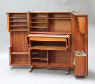A 1960's Home Office New Craft Limited teak home office with well fitted interior 112cm h x 84cm w x 53cm d, labelled to the interior (cigarette burn to the top and contact marks in places, no key)