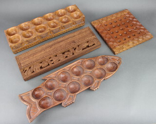 A Nigerian carved hardwood fish shaped dish fitted 12 recepticals 5cm h x 58cm w x 20cm d, 2 rectangular 12 bowl recepticals and 1 other bowl 