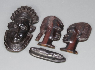A carved ebony mask 46cm x 20cm, 1 other 26cm x 7cm and 2 carved hardwood masks of a lady and gentleman 30cm x 17cm 