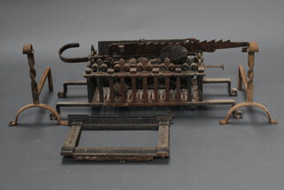An iron fire basket and fire dogs 40cm h x 100cm w x 20cm d (rusted), 2 rectangular cast fire dogs depicting blacksmith scene 25cm x 41cm and 25cm x 48cm, a cobblers shoe last, an iron pod hook, a carved fire surround 40cm x 46cm d etc