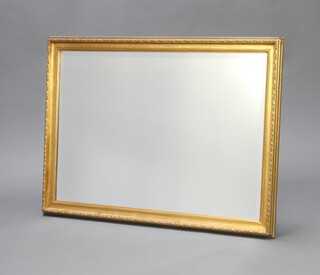 A rectangular bevelled plate wall mirror contained in a gilt frame 102cm x 72cm 