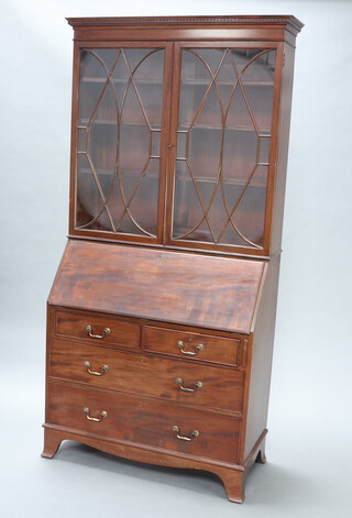 A 1930's Chippendale style mahogany bureau bookcase with moulded and dentil cornice, fitted shelves enclosed by astragal glazed doors, the fall front revealing a well fitted interior above 2 short and 2 long drawers, raised on splayed bracket feet 210cm h x 99cm w x 45cm d (sun bleached) 